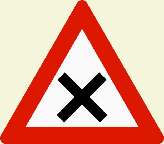 Rote und weiße dreieckige Warnstraße mit einem schwarzen Kreuz, die eine mögliche Straßenüberquerungsgefahr anzeigt.